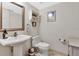 Cozy powder room with a pedestal sink, decorative mirror, and tiled floor at 1660 Killean Ct, Apopka, FL 32712