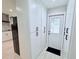 Hallway with white cabinets and black hardware, leading to an exterior door at 1660 Killean Ct, Apopka, FL 32712