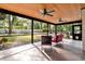 Screened in patio with tile flooring, two ceiling fans, and outdoor furniture at 1660 Killean Ct, Apopka, FL 32712
