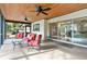 Large screened in patio featuring tile flooring and red outdoor furniture at 1660 Killean Ct, Apopka, FL 32712