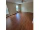 Bedroom features wood floors, a ceiling fan, and natural light from the window at 4530 Brook Hollow Cir, Winter Springs, FL 32708