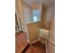 Hallway features wood flooring, staircase, neutral walls and access to bathroom and bedroom at 4530 Brook Hollow Cir, Winter Springs, FL 32708