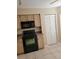 Cozy kitchen featuring black appliances, tile floors, and light-colored cabinetry at 4530 Brook Hollow Cir, Winter Springs, FL 32708