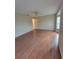 Spacious living room featuring wood floors, a ceiling fan, and natural light from the window at 4530 Brook Hollow Cir, Winter Springs, FL 32708
