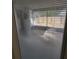 View of patio and fenced-in yard through window with blinds at 4530 Brook Hollow Cir, Winter Springs, FL 32708