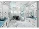 Spa-like bathroom with marble finishes, soaking tub, and double vanity at 7811 Skiing Way, Winter Garden, FL 34787