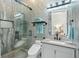 Modern bathroom with glass shower, pebble floor, and stylish tile at 7811 Skiing Way, Winter Garden, FL 34787