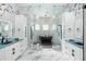 Spa-like bathroom with marble finishes, soaking tub, and double vanity at 7811 Skiing Way, Winter Garden, FL 34787