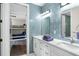 Double vanity bathroom with blue tile and access to bunk room at 7811 Skiing Way, Winter Garden, FL 34787