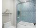 Elegant bathroom with blue tile and a bathtub at 7811 Skiing Way, Winter Garden, FL 34787