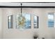 Elegant dining room with a stunning chandelier and lake views at 7811 Skiing Way, Winter Garden, FL 34787