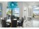 Elegant dining room with lake view, spacious table, and modern chandelier at 7811 Skiing Way, Winter Garden, FL 34787