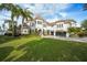Luxury waterfront home with expansive lawn and mature landscaping at 7811 Skiing Way, Winter Garden, FL 34787