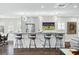 Open concept kitchen with large island and contemporary pendant lighting at 7811 Skiing Way, Winter Garden, FL 34787