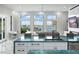 Open floor plan features a modern kitchen and living area with water views at 7811 Skiing Way, Winter Garden, FL 34787