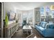 Living room with hardwood floors, large windows, and comfortable seating at 7811 Skiing Way, Winter Garden, FL 34787