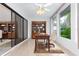 Well lit home office features tile floor, sliding glass doors, and large windows with backyard view at 104 Coventry Ln, Haines City, FL 33844