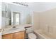 Cozy bathroom with vanity, mirror, and a tiled shower-tub combination at 14216 Boca Key Dr, Orlando, FL 32824