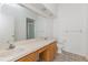 Bathroom featuring double sinks, large mirror, shower and toilet at 14216 Boca Key Dr, Orlando, FL 32824