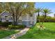 Charming home featuring a well-maintained lawn, walkway, and beautiful landscaping at 14216 Boca Key Dr, Orlando, FL 32824