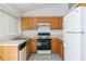 Kitchen featuring wood cabinets, neutral countertops, and appliances at 14216 Boca Key Dr, Orlando, FL 32824