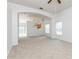 Bright living room with neutral carpet, ceiling fan, and windows for natural light at 14216 Boca Key Dr, Orlando, FL 32824