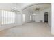 Bright living room features neutral carpet, archways, and large windows at 14216 Boca Key Dr, Orlando, FL 32824