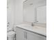 Bathroom featuring single vanity with stone countertop, large mirror, and a view of the toilet and shower at 2378 Broadbrook Dr, St Cloud, FL 34771
