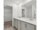 Bathroom features double sink vanity with stone countertop, large mirror, and separate room for walk-in closet and shower at 2378 Broadbrook Dr, St Cloud, FL 34771