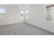 Bright bedroom features neutral carpet, crisp white walls, and plenty of natural light from multiple windows at 2378 Broadbrook Dr, St Cloud, FL 34771