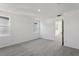 Bright bedroom features neutral carpet, crisp white walls, and natural light from windows and entryway at 2378 Broadbrook Dr, St Cloud, FL 34771