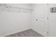 Walk-in closet featuring wire shelving and neutral carpet next to the utility box at 2378 Broadbrook Dr, St Cloud, FL 34771