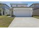 Beautiful home with a spacious two-car garage, charming entry, and green landscaping at 2378 Broadbrook Dr, St Cloud, FL 34771