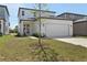 Beautiful home with a spacious two-car garage, charming entry, and green landscaping at 2378 Broadbrook Dr, St Cloud, FL 34771