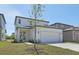 Modern home with a large two-car garage, landscaping, and inviting entrance at 2378 Broadbrook Dr, St Cloud, FL 34771