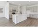 Modern kitchen with stainless steel appliances, a large island, and stylish gray cabinets at 2378 Broadbrook Dr, St Cloud, FL 34771