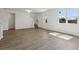 Bright living room featuring hardwood floors, large windows, and easy access to the staircase at 2378 Broadbrook Dr, St Cloud, FL 34771