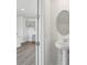 Powder room with pedestal sink and decorative mirror; kitchen in background at 2378 Broadbrook Dr, St Cloud, FL 34771