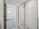 This bathroom features a walk-in shower with glass door, white subway tile surround, and view into adjacent bedroom at 2378 Broadbrook Dr, St Cloud, FL 34771