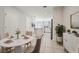 Open-concept dining room featuring white tile floors, a round table, and views of the kitchen at 251 Blueberry Ln, Davenport, FL 33837