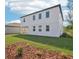 Backyard view of a modern two-story home with a covered patio and lush green grass at 339 Conway Ave, St Cloud, FL 34771