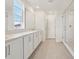 Bright bathroom featuring double sinks, quartz countertops, and a glass enclosed shower at 339 Conway Ave, St Cloud, FL 34771
