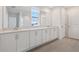Bathroom featuring double sinks with quartz countertops and white cabinets at 339 Conway Ave, St Cloud, FL 34771