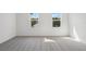 Bright bedroom features two windows and neutral carpet at 339 Conway Ave, St Cloud, FL 34771