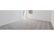 Bright bedroom featuring a window, soft carpet, and fresh, white walls, creating a peaceful atmosphere at 339 Conway Ave, St Cloud, FL 34771