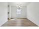 Spacious dining room with stylish floors, a modern chandelier, and ample space for entertaining guests at 339 Conway Ave, St Cloud, FL 34771