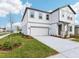 Inviting two-story home with a well-manicured lawn and a two-car garage on a clear, sunny day at 339 Conway Ave, St Cloud, FL 34771