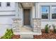 Inviting home entrance with stone pillar accents, a dark front door and coordinated landscaping at 339 Conway Ave, St Cloud, FL 34771