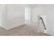 Bright hallway featuring neutral carpet and an open doorway at 339 Conway Ave, St Cloud, FL 34771