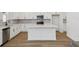 Spacious kitchen showcasing white cabinets, quartz countertops, stainless steel appliances, and a center island at 339 Conway Ave, St Cloud, FL 34771